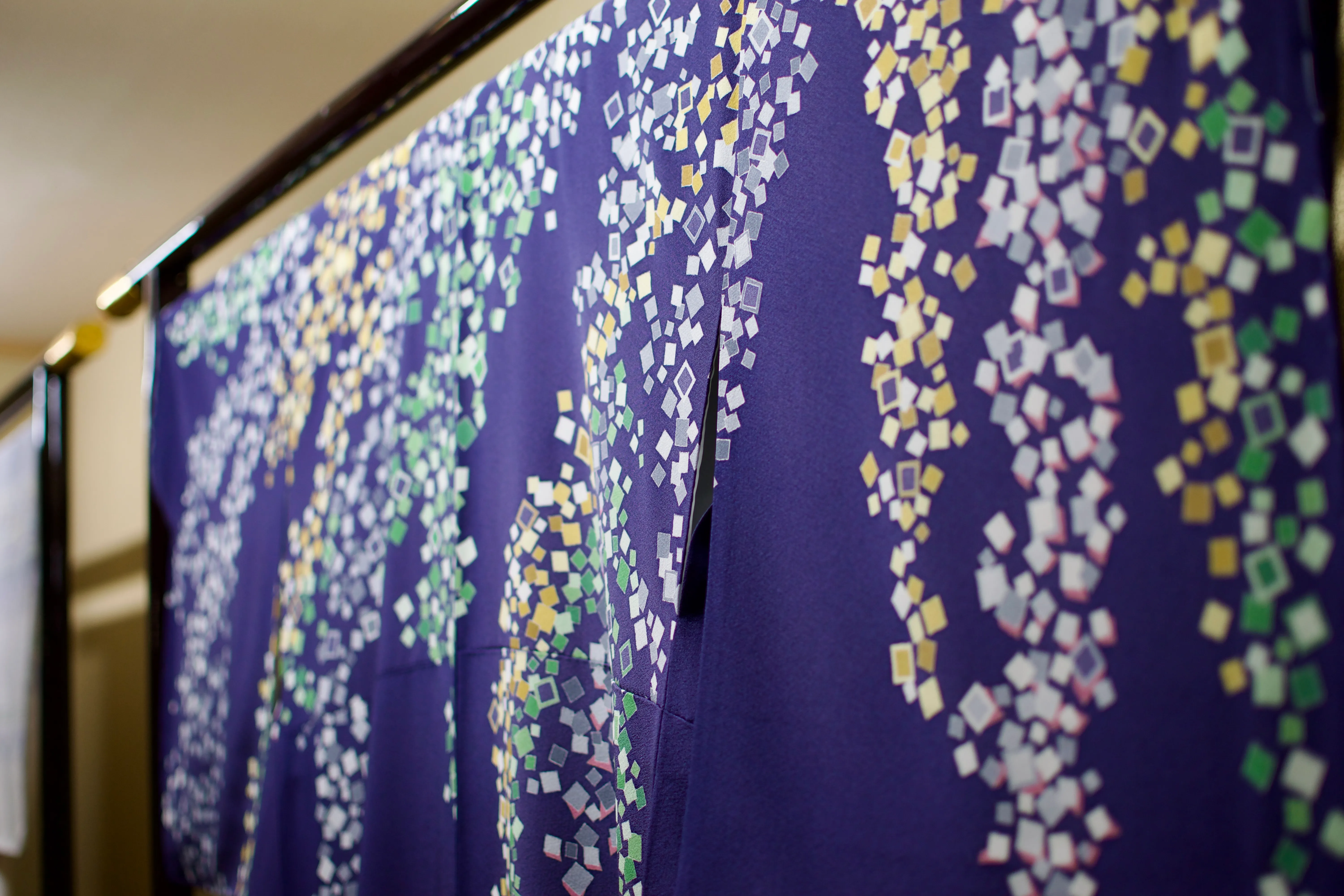 A blue kimono with a sprinkled pattern of white, yellow, and green squares.