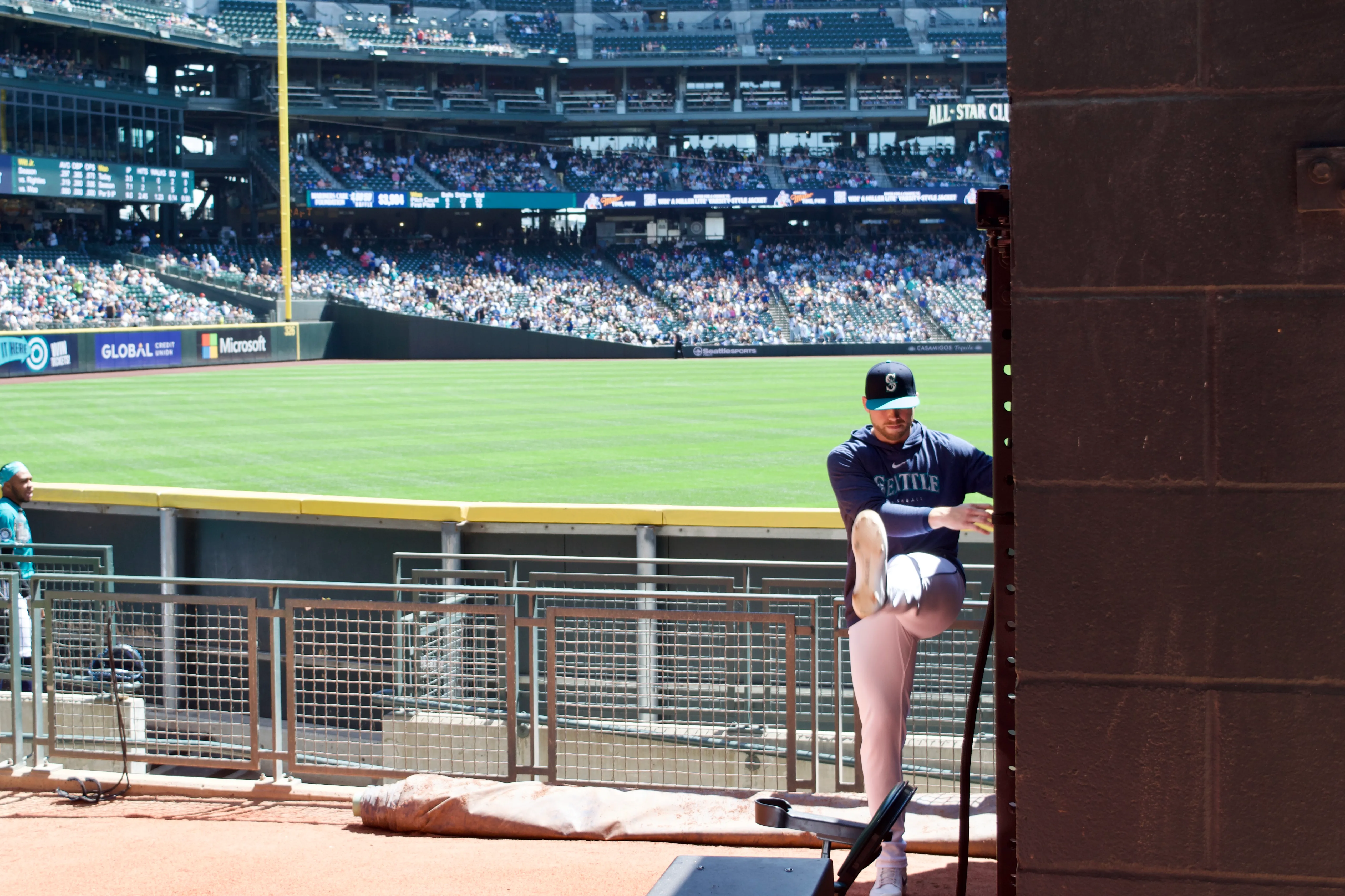 One of the Seattle Mariners' relief pitchers stretches his legs in the bullpen