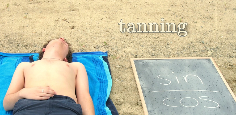 A beachgoer lies on a towel next a chalkboard with the expression sin/cos. The caption explains that both are 'tanning'