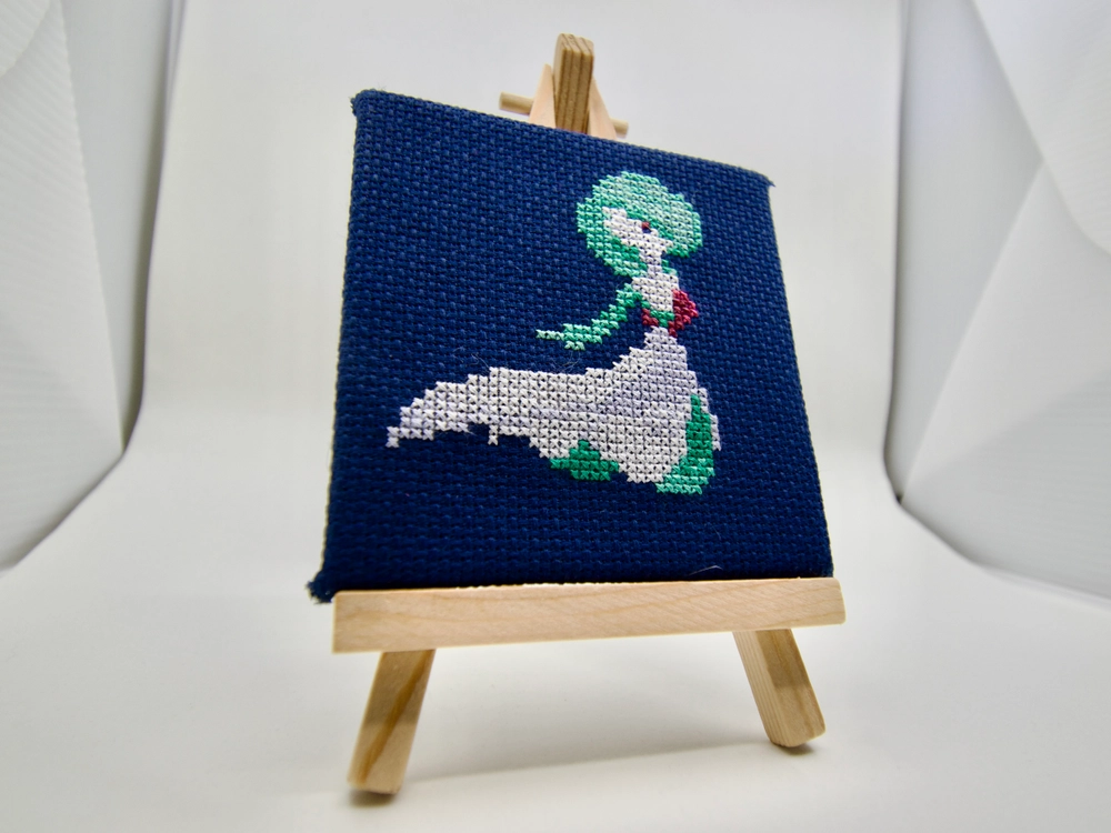 A cross-stitch of the embrace Pokémon Gardevoir