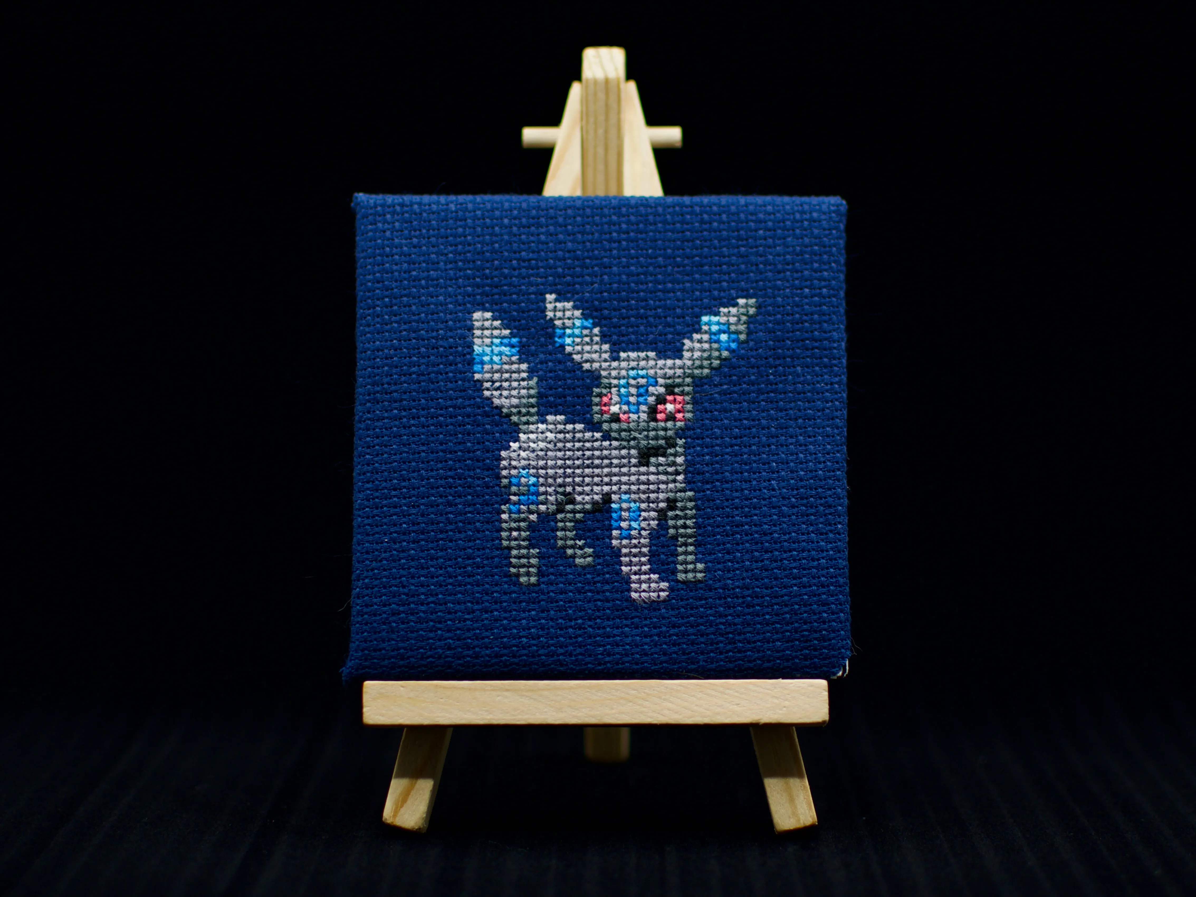 A cross-stitch of the moonlight Pokémon Umbreon