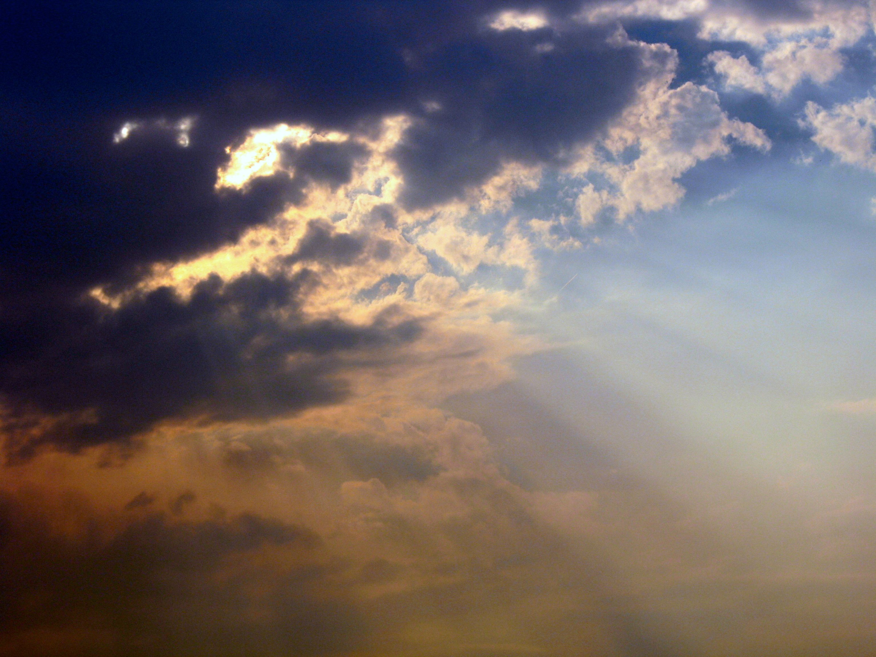 Golden light breaks through dark clouds