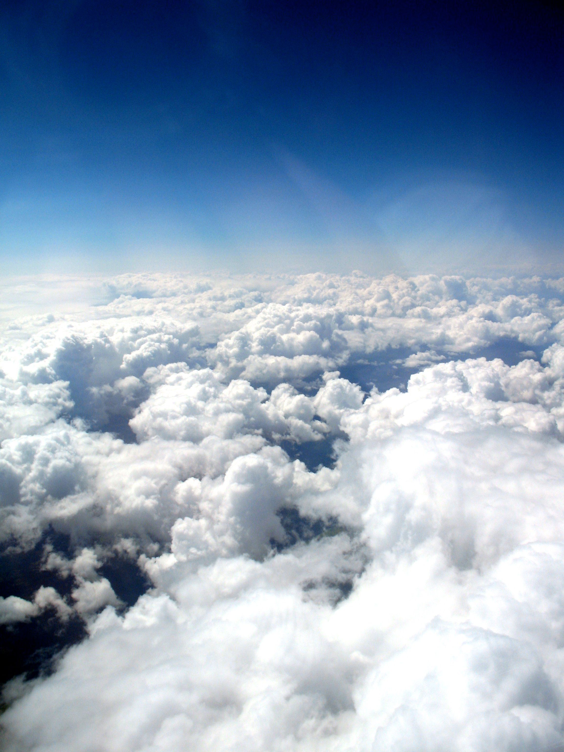Sunlight illuminates a sea of clouds from above