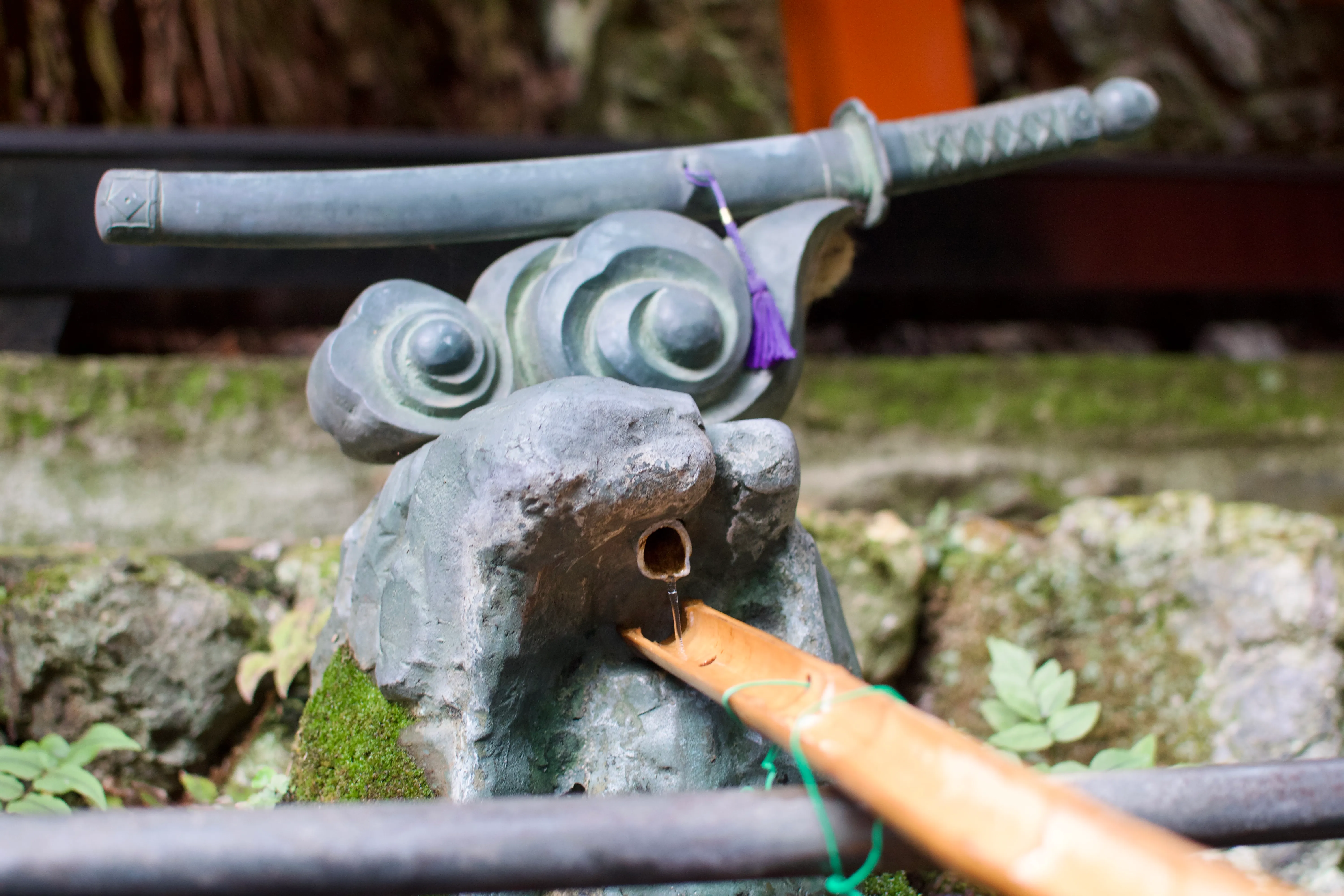 A fountain topped with a cloud and a sword, but which could also be viewed as some sort of cute gremlin