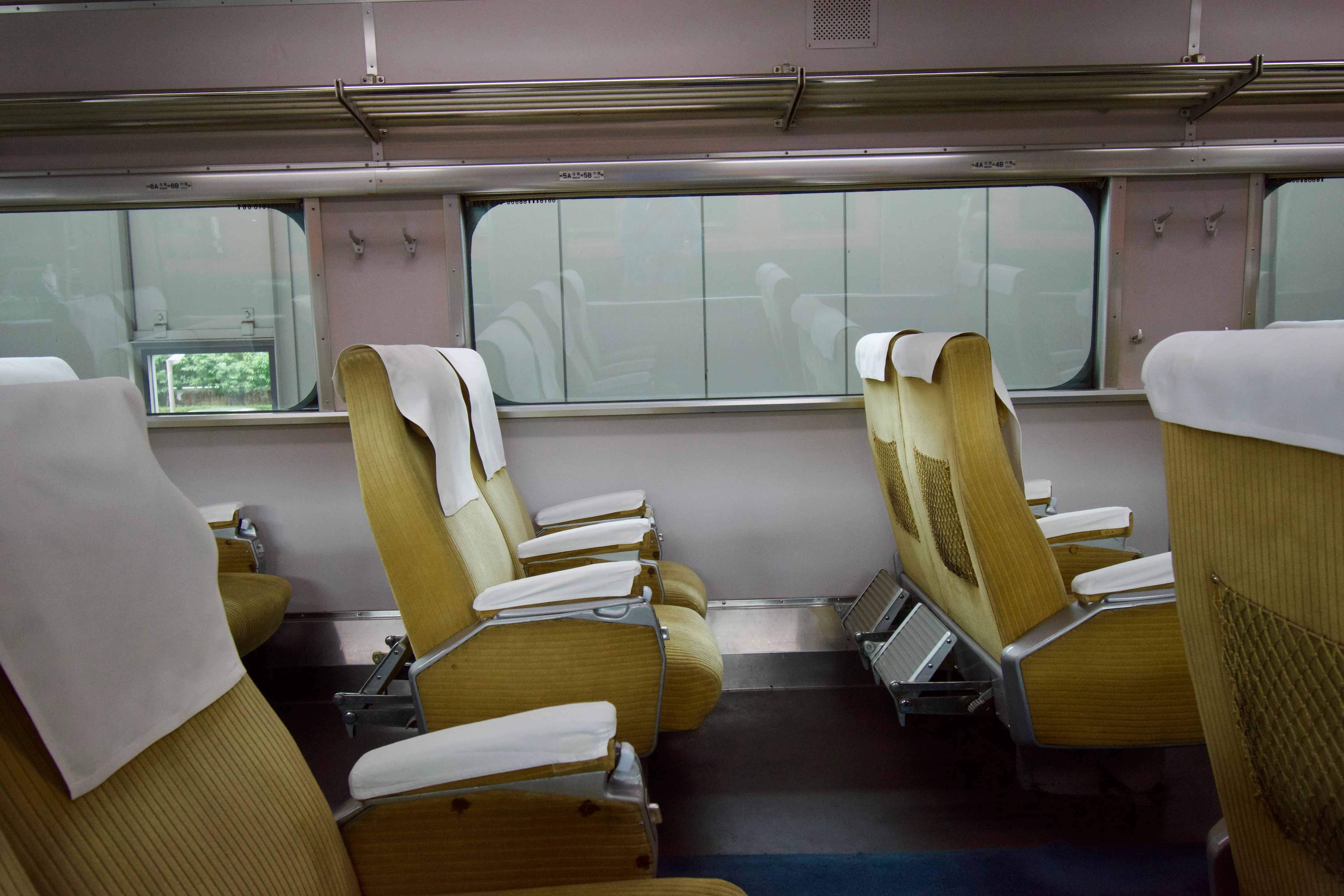 Spacious seats in the interior of an original 1960s bullet train.
