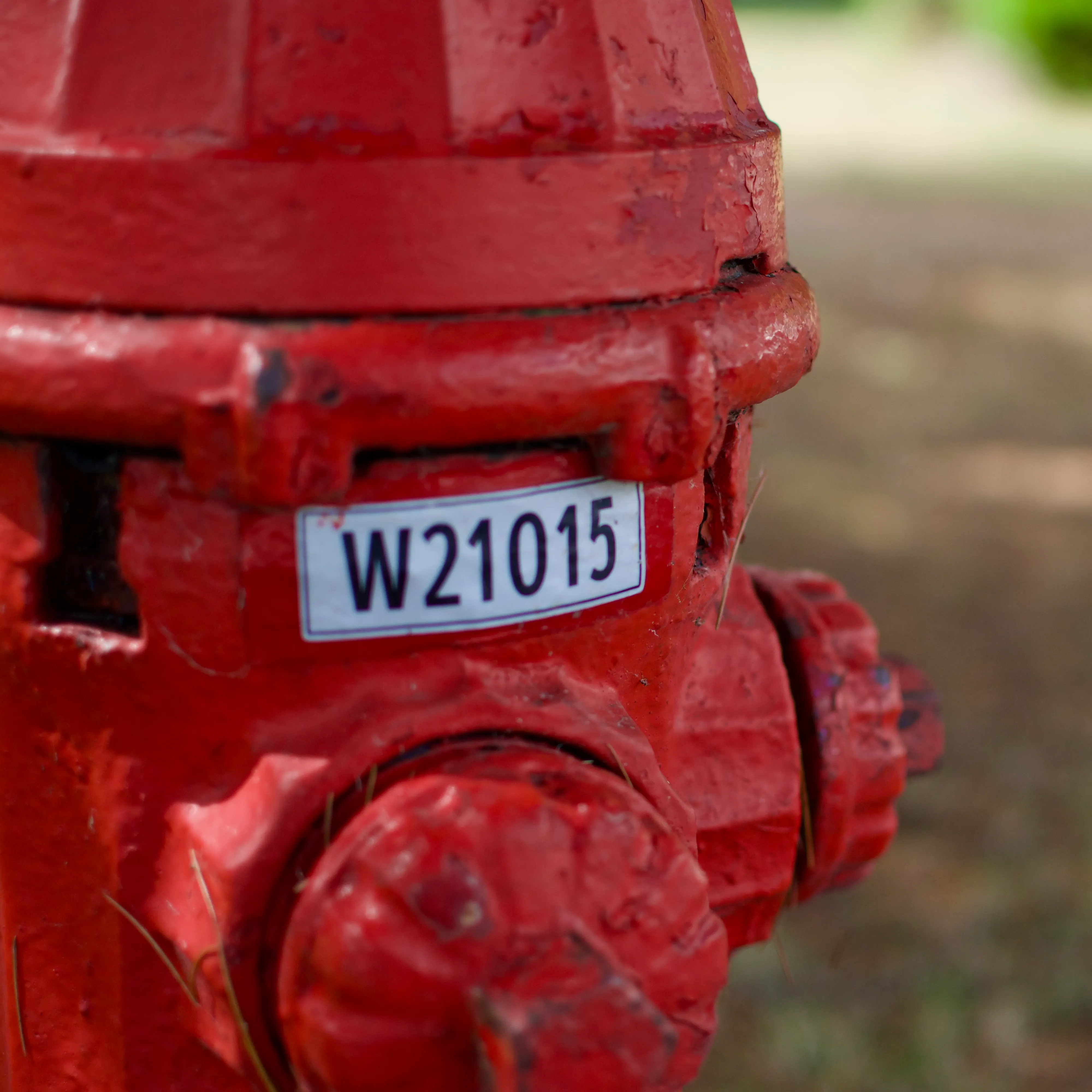 A red fire hydrant with a red-bordered ID label