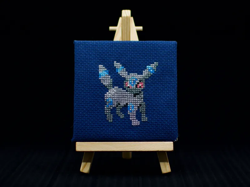 A cross-stitch of the Pokémon Umbreon.