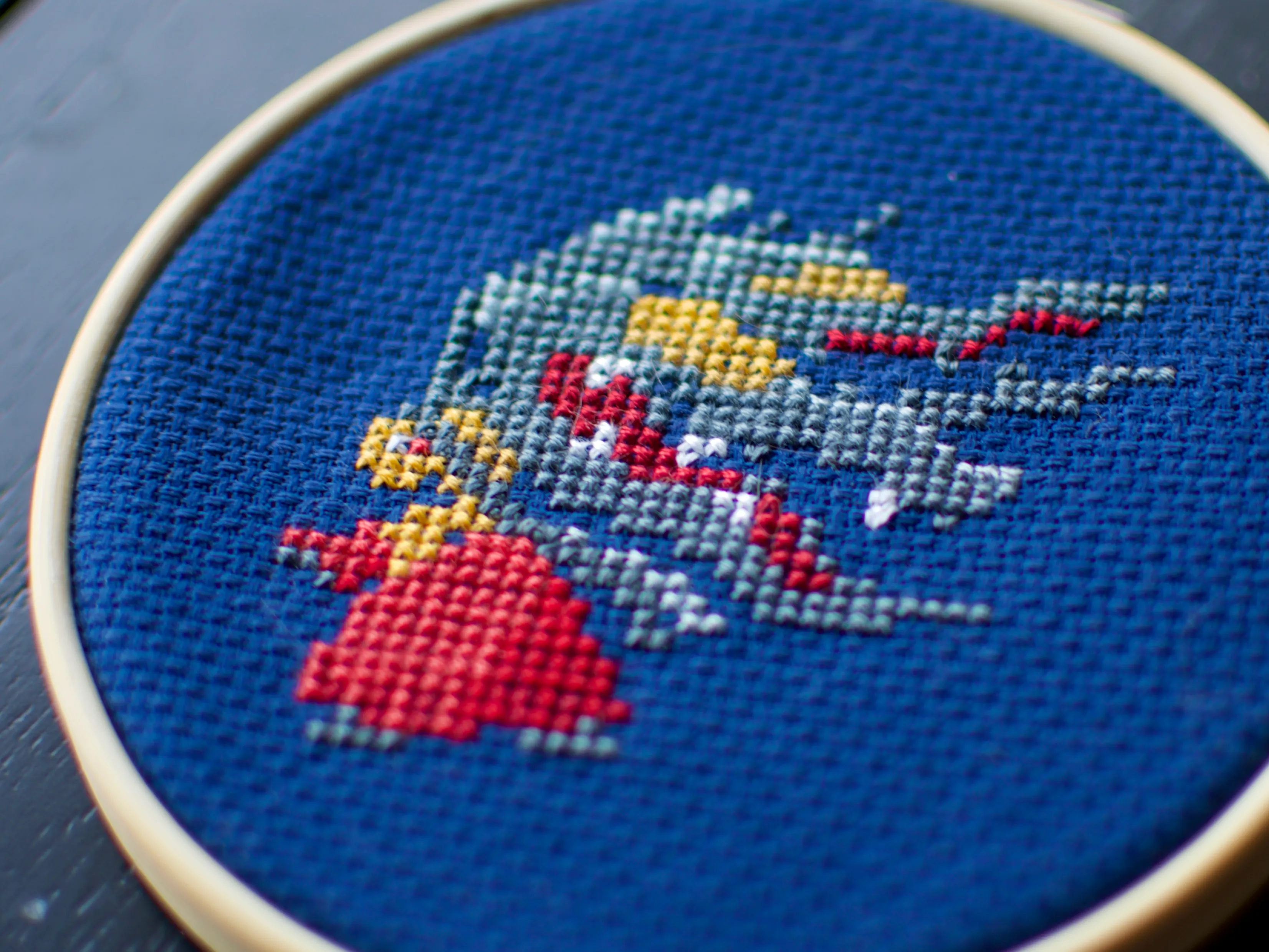 A cross-stitch of the mega-evolved version of the Pokémon Mawile.