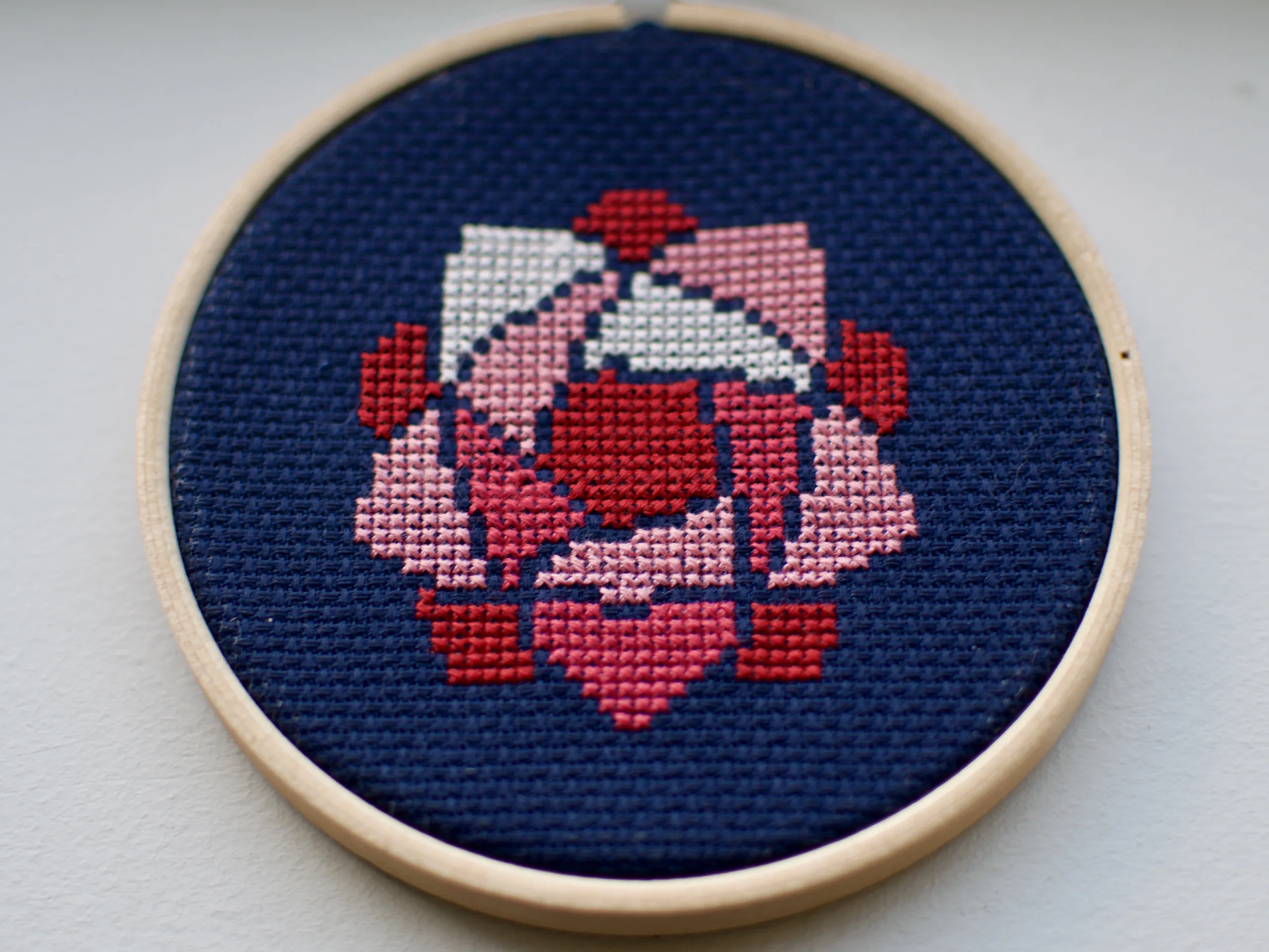 Cross-stitch rose logo