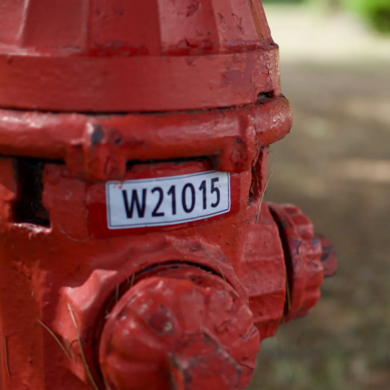 A red fire hydrant with a red-bordered ID label