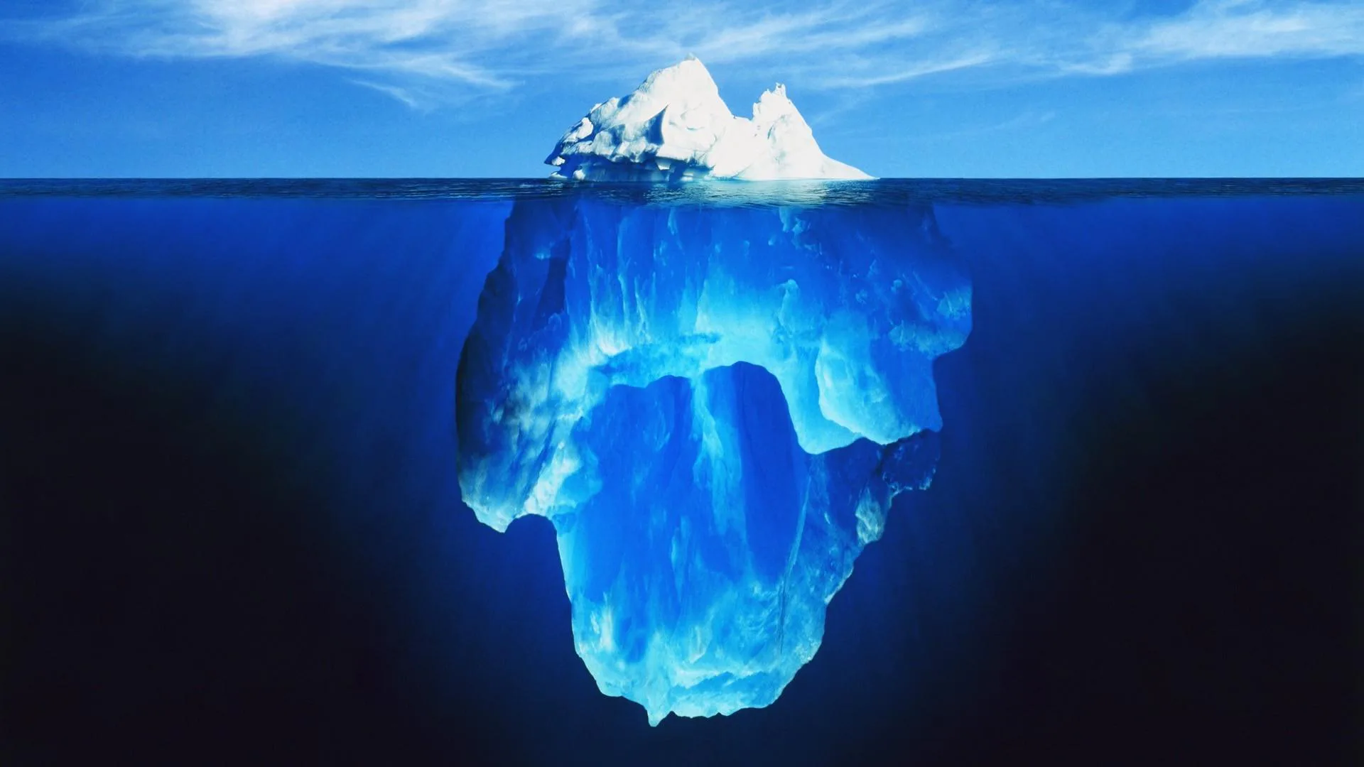 A stereotypical depiction of an iceberg with a tower of ice below the water